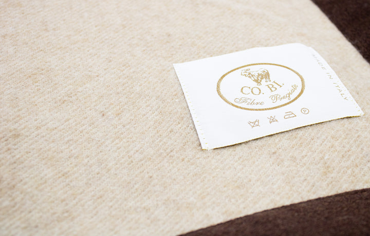 Particolare coperta beige bordo marrone