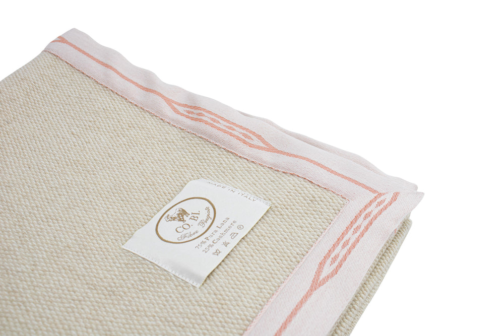 particolare lavorazione della coperta beige con bordo rosa